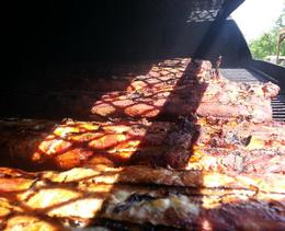Image of pork loins being smoked on one of Wolf Creek BBQ's Smokers.